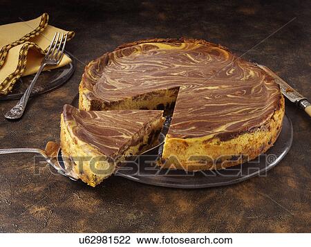 Stock Image - Marbled pumpkin cheesecake. Fotosearch