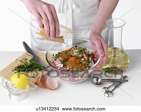 Picture - Mixing the ingredients to make kebabs. Fotosearch