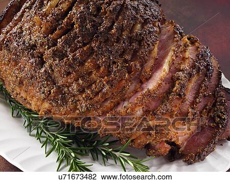 Stock Image - Mustard glazed spiral ham. Fotosearch