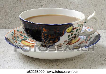 Stock Image - One Cup Of Tea With Milk In Swansea Cottage China Tea Cup And Saucer. Fotosearch