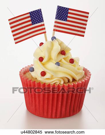 Stock Photography - One Cupcake In Red Cake Case With Buttercream Topping And Decorated With Sprinkles And Two Small American Flags, On White Background. Fotosearch