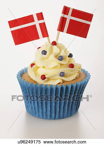 Stock Photography - One Cupcake With Buttercream Topping Decorated With Two Danish Flags, Blue Cake Case, On White. Fotosearch