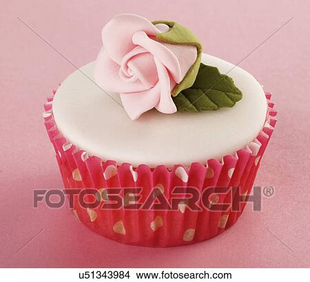 One Perfect White Iced Cupcake In Pink Polka Dot Cake Case Decorated With Single Pink Sugar Craft Rose, On Pink Tabletop View Large Photo Image Picture - One Perfect White Iced Cupcake In Pink Polka Dot Cake Case Decorated With Single Pink Sugar Craft Rose, On Pink Tabletop. Fotosearch