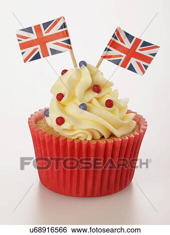 One Themed British Celebration Cupcake, Red Cake Case Filled With Sponge Cake, Topped With Buttercream Red And Blue Sprinkles And Small Union Jack Flags, On White View Large Photo Image Stock Photograph - One Themed British Celebration Cupcake, Red Cake Case Filled With Sponge Cake, Topped With Buttercream Red And Blue Sprinkles And Small Union Jack Flags, On White. Fotosearch