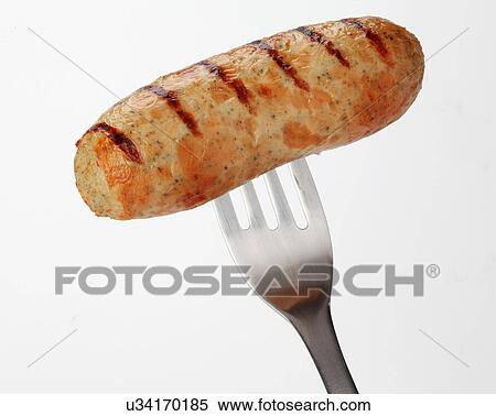 Stock Photography - One Whole Cooked Chicken Sausage On End Of Fork. Fotosearch