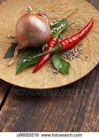 Stock Photograph - Onion chillies curry leaves fennel seeds. Fotosearch