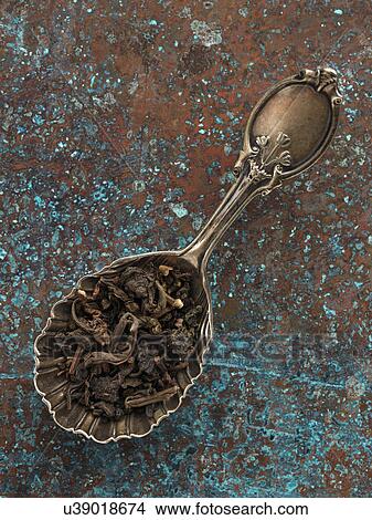 Oolong tea leaves in an antique tea caddy spoon View Large Photo Image Picture - Oolong tea leaves in an antique tea caddy spoon. Fotosearch