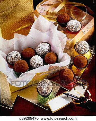 Stock Image - Open Box Of Truffles With Gift Wrap, Pen And Gift Tag. Fotosearch