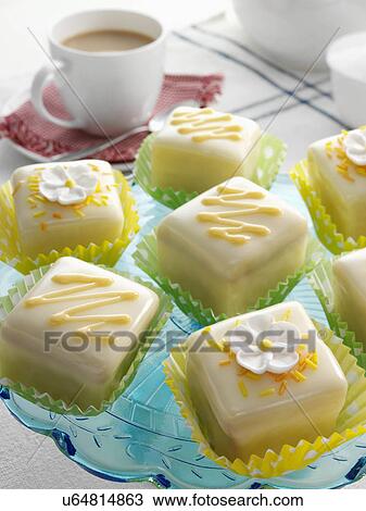 Stock Image - Orange flavoured fondant fancies. Fotosearch