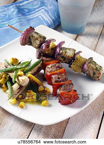 Picture - orkand pineapple and chilli beek kebabs with corn and palm heart salad. Fotosearch