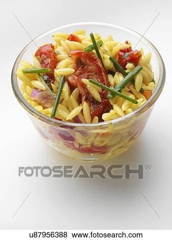 Orzo rice sun dried tomato salad in glass bowl on a white background View Large Photo Image Stock Photo - Orzo rice sun dried tomato salad in glass bowl on a white background. Fotosearch