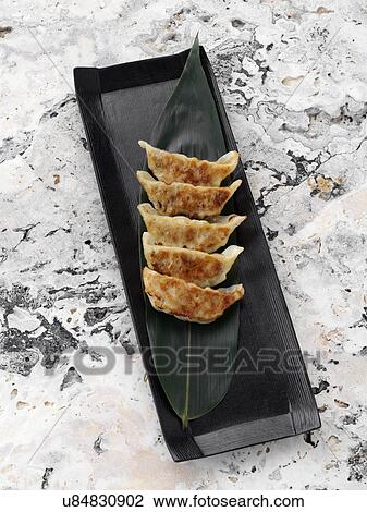 Stock Image - Pan fried gyoza. Fotosearch