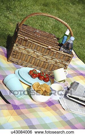 Stock Photograph - Picnic Hamper And Blanket On Grass. Fotosearch