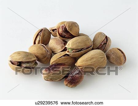 Pistachio nuts on a white background View Large Photo Image Stock Photograph - Pistachio nuts on a white background. Fotosearch