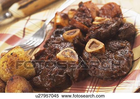 Stock Photography - Plate Of Ossobucco Served With Roasted Potatoes. Fotosearch