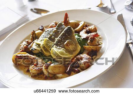 Plate Of Roasted Sea Bass Served With Vegetables View Large Photo Image Stock Photo - Plate Of Roasted Sea Bass Served With Vegetables. Fotosearch