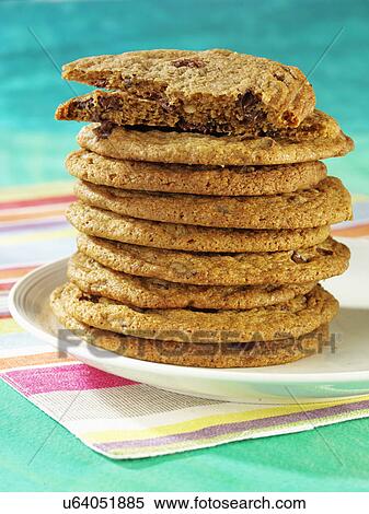 Stock Photography - Plate With Stack Of Chocolate Chip Cookies, Pastel Striped Table Mat. Fotosearch