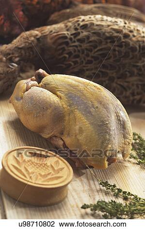 Stock Image - Plucked Pheasant Ready For The Oven. Fotosearch