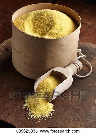Stock Photography - Polenta in a scoop and barrel. Fotosearch