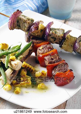 Pork and pineapple and chilli beef kebabs with corn and palm heart salad View Large Photo Image Stock Photo - Pork and pineapple and chilli beef kebabs with corn and palm heart salad. Fotosearch