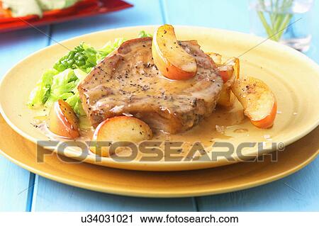 Stock Image - Pork Chop Served With Cider Sauce. Fotosearch