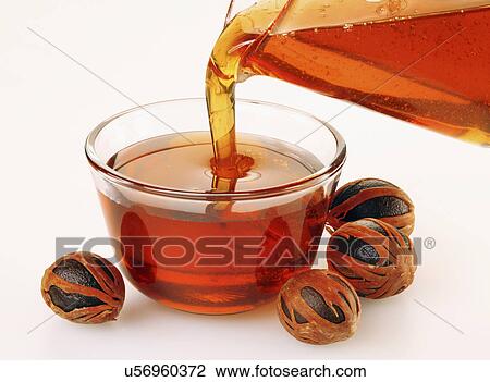 Pouring Nutmeg Syrup Into Bowl, Whole Nutmeg With Mace, On White Tabletop View Large Photo Image Stock Image - Pouring Nutmeg Syrup Into Bowl, Whole Nutmeg With Mace, On White Tabletop. Fotosearch