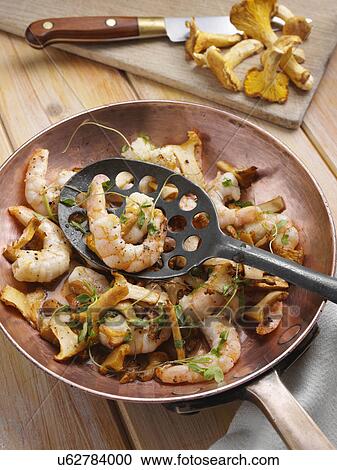 Stock Image - Prawns and girolle mushrooms. Fotosearch
