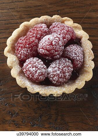 Stock Image - Raspberry tart on a wood background. Fotosearch