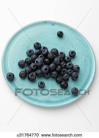 Ripe blueberries on a turquoise plate on a white background View Large Photo Image Stock Image - Ripe blueberries on a turquoise plate on a white background. Fotosearch