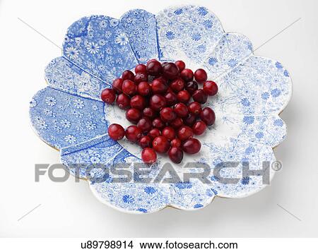 Ripe cranberries on an antique plate on a white background View Large Photo Image Picture - Ripe cranberries on an antique plate on a white background. Fotosearch