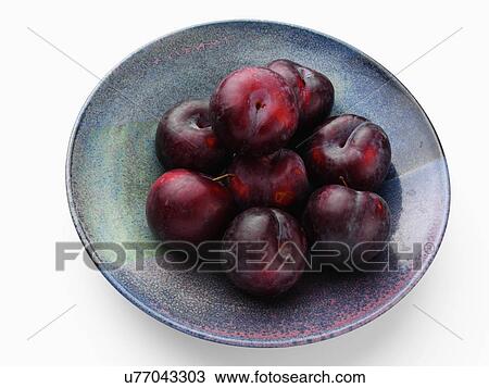 Ripe plums in a blue bowl on a white background View Large Photo Image Stock Image - Ripe plums in a blue bowl on a white background. Fotosearch