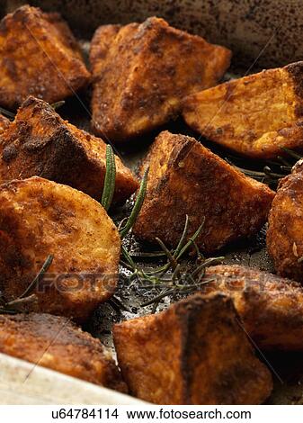 Roast potatoes and sweet potatoes View Large Photo Image Picture - Roast potatoes and sweet potatoes. Fotosearch