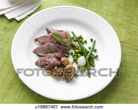 Roast turkey thigh with stuffing onion green bens peas and gravy sage thyme View Large Photo Image Stock Photo - Roast turkey thigh with stuffing onion green bens peas and gravy sage thyme. Fotosearch