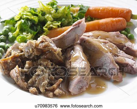 Roast turkey thigh with stuffing carrots cabbage peas and gravy View Large Photo Image Stock Photograph - Roast turkey thigh with stuffing carrots cabbage peas and gravy. Fotosearch
