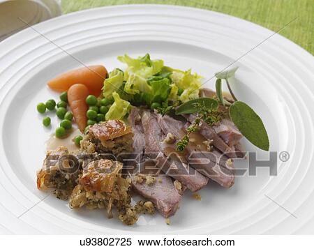 Stock Photography - Roast turkey thigh with stuffing carrots cabbage peas and gravy. Fotosearch