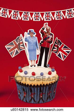 Royal Themed British Celebration Cupcake, White Iced Sponge Fairy Or Cup Cake, Topped With Red And Blue Sprinkles Two Small Union Jack Flags, A Waving Queen Elizabeth, And Prince Philip. On Red Background With Union Jack Bunting View Large Photo Image Stock Photography - Royal Themed British Celebration Cupcake, White Iced Sponge Fairy Or Cup Cake, Topped With Red And Blue Sprinkles Two Small Union Jack Flags, A Waving Queen Elizabeth, And Prince Philip. On Red Background With Union Jack Bunting. Fotosearch