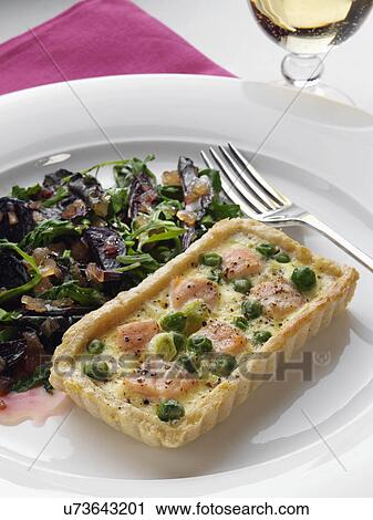 Stock Image - Salmon quiche with beetroot salad. Fotosearch