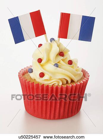Stock Photo - Single Cupcake With Two French Flags And Buttercream Topping, In Red Cake Case, White Background. Fotosearch