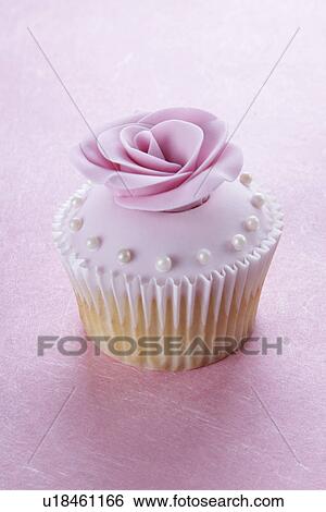 Single Pink Cupcake With Rose And Pearl Decoration, On Pink Tabletop View Large Photo Image Stock Photograph - Single Pink Cupcake With Rose And Pearl Decoration, On Pink Tabletop. Fotosearch
