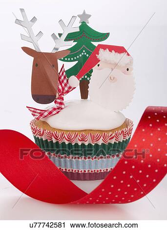 Single White Iced Sponge Cupcake In Paper Case Topped With Father Christmas, Reindeer And Christmas Tree, White Background, Red Ribbon View Large Photo Image Stock Image - Single White Iced Sponge Cupcake In Paper Case Topped With Father Christmas, Reindeer And Christmas Tree, White Background, Red Ribbon. Fotosearch