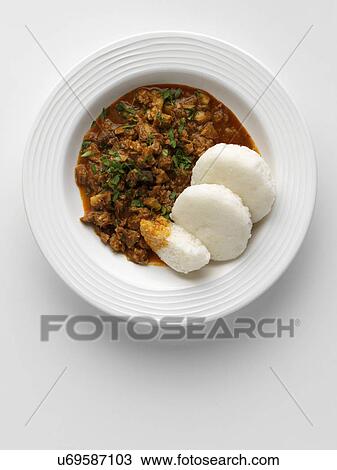 Stock Image - Sorpatel Goan curry with sannas rice bread. Fotosearch