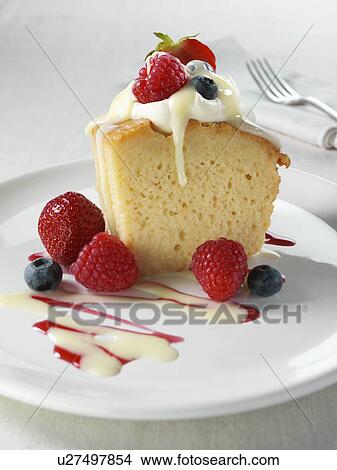 Picture - Spanish traditional sponge cake with evaporated and condensed milk topped with whipped cream and fruit. Fotosearch