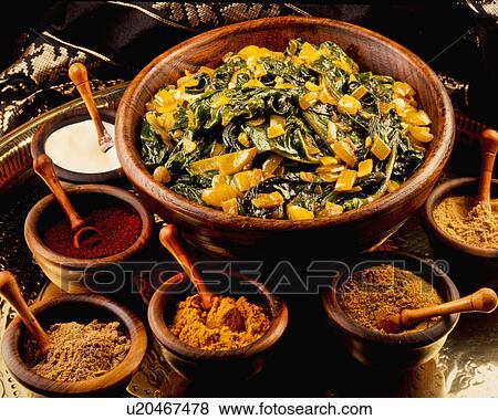 Stock Photo - Spinach And Onion Curry In Wooden Bowl With Assorted Spices In Small Wooden Bowls, All On Brass Tray. Fotosearch