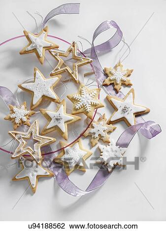 Stock Image - Star shaped iced Christmas biscuits. Fotosearch