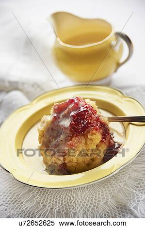 Stock Photography - Steamed Jam Pudding Served With Custard. Fotosearch
