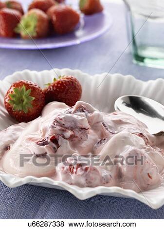 Stock Photo - Strawberry yoghourt with red ripe strawberries. Fotosearch