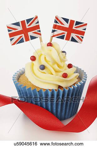 Themed British Celebration Cupcake, Blue Cake Case With Sponge Cupcake, Topped With Buttercream Red And Blue Sprinkles And Two Small Union Jack Flags, On White With Red Ribbon View Large Photo Image Stock Photograph - Themed British Celebration Cupcake, Blue Cake Case With Sponge Cupcake, Topped With Buttercream Red And Blue Sprinkles And Two Small Union Jack Flags, On White With Red Ribbon. Fotosearch