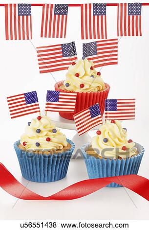 Three Cupcakes In Red And Blue Cases Decorated With Buttercream Fondant And Topped With Small American Flags And Sprinkles, White Tabletop With Bunting And Red Ribbon View Large Photo Image Stock Photo - Three Cupcakes In Red And Blue Cases Decorated With Buttercream Fondant And Topped With Small American Flags And Sprinkles, White Tabletop With Bunting And Red Ribbon. Fotosearch