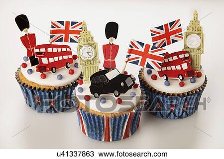 Three London Themed British Celebration Cupcakes, White Iced Sponge Fairy Cake, Topped With Red And Blue Sprinkles Small Union Jack Flags, Big Ben, Red Bus, London Taxi And Guardsman, On White View Large Photo Image Stock Image - Three London Themed British Celebration Cupcakes, White Iced Sponge Fairy Cake, Topped With Red And Blue Sprinkles Small Union Jack Flags, Big Ben, Red Bus, London Taxi And Guardsman, On White. Fotosearch