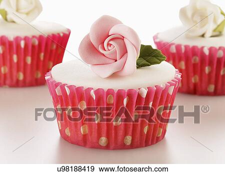 Three Perfect White Iced Cupcakes In Pink Polka Dot Cake Cases Decorated With Single Sugar Craft Roses, On White Background View Large Photo Image Stock Photo - Three Perfect White Iced Cupcakes In Pink Polka Dot Cake Cases Decorated With Single Sugar Craft Roses, On White Background. Fotosearch